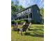 Charming two-story home featuring a welcoming porch, lush lawn and patio with fire pit at 5830 Wills Wood Cir, Cumming, GA 30040