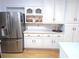 Bright, eat-in kitchen with stainless steel appliances, white cabinets, and ample counter space at 5830 Wills Wood Cir, Cumming, GA 30040