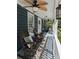 Inviting front porch with rocking chairs, ceiling fans, and a lantern, perfect for relaxing outdoors at 5830 Wills Wood Cir, Cumming, GA 30040