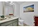 Cozy powder room with a modern vanity, a tiled floor, and a decorative mirror at 5830 Wills Wood Cir, Cumming, GA 30040