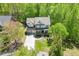 Beautiful aerial view of this house with a three car garage, and landscaped yard at 7035 W Mountain Xing, Cumming, GA 30041