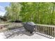 Back deck features a grill and overlooks a beautiful green space creating an ideal spot for outdoor entertaining at 7035 W Mountain Xing, Cumming, GA 30041
