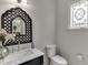 Charming bathroom with a decorative mirror, stained glass window, and elegant fixtures at 7035 W Mountain Xing, Cumming, GA 30041