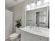 Well-lit bathroom featuring a marble countertop vanity, a shower with a curtain, and modern fixtures at 7035 W Mountain Xing, Cumming, GA 30041