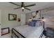 Bedroom featuring a brick accent wall, modern lighting, and comfortable metal bed frame at 7035 W Mountain Xing, Cumming, GA 30041