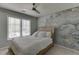 Serene bedroom with a decorative accent wall, plush bedding, and bright natural light at 7035 W Mountain Xing, Cumming, GA 30041