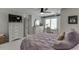 Bedroom featuring a ceiling fan, window desk area, a white dresser, and a door to the walk-in closet at 7035 W Mountain Xing, Cumming, GA 30041