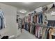 Walk-in closet features rows of shelving and rods for ample clothing and storage at 7035 W Mountain Xing, Cumming, GA 30041