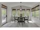 A light and airy dining area featuring multiple windows, a modern light fixture, and light colored floors at 7035 W Mountain Xing, Cumming, GA 30041