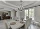 Elegant dining room with chandelier, seating for six, and archway to office at 7035 W Mountain Xing, Cumming, GA 30041