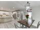 Dining area showing view of modern kitchen, stainless appliances, and stone backsplash at 7035 W Mountain Xing, Cumming, GA 30041