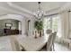 Charming dining room with a chandelier, crown molding, and views into the adjacent office space at 7035 W Mountain Xing, Cumming, GA 30041