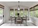 Bright dining area features large windows, hardwood floors, and elegant lighting, perfect for Gathering meals at 7035 W Mountain Xing, Cumming, GA 30041
