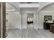 Inviting foyer with wood-look floors, archways, and view into the living room with many windows at 7035 W Mountain Xing, Cumming, GA 30041