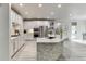 Well-lit kitchen with stainless appliances, white cabinetry, and island featuring barstool seating at 7035 W Mountain Xing, Cumming, GA 30041