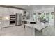 Beautiful kitchen featuring white cabinetry, stainless steel appliances, and a stylish island with stone accents at 7035 W Mountain Xing, Cumming, GA 30041