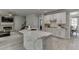 Bright open kitchen with stone accents, stainless steel appliances, and a large island with a stone base at 7035 W Mountain Xing, Cumming, GA 30041