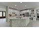 Open concept kitchen with white cabinetry, stone accents, stainless steel appliances, and large center island at 7035 W Mountain Xing, Cumming, GA 30041