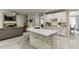 Modern kitchen with white cabinets, stainless appliances, stone backsplash, and center island with stone accent at 7035 W Mountain Xing, Cumming, GA 30041