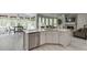 Open kitchen with white cabinets, stainless steel appliances, and view to living and dining areas at 7035 W Mountain Xing, Cumming, GA 30041