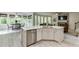 Open-concept kitchen with a center island, modern appliances, and a breakfast nook with large windows at 7035 W Mountain Xing, Cumming, GA 30041