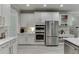 Modern kitchen with stainless appliances and white cabinetry provides ample storage and cooking space at 7035 W Mountain Xing, Cumming, GA 30041