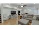 Large living area featuring hardwood floors, a ceiling fan, and comfortable seating at 7035 W Mountain Xing, Cumming, GA 30041
