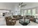 Open concept living area with kitchen, stainless appliances, stone counters, and a cozy seating arrangement at 7035 W Mountain Xing, Cumming, GA 30041