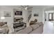Inviting living room showcases a stone fireplace, large windows, and comfortable seating arrangement at 7035 W Mountain Xing, Cumming, GA 30041