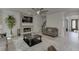 Cozy living room featuring a stone fireplace, TV, ceiling fan and an open concept floorplan with gray colored walls at 7035 W Mountain Xing, Cumming, GA 30041