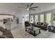 Bright open living room and kitchen area with a large fan and plenty of natural light at 7035 W Mountain Xing, Cumming, GA 30041