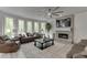 Bright living room with fireplace, large windows, and comfortable seating. The room is open and airy at 7035 W Mountain Xing, Cumming, GA 30041