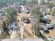 Aerial view showcases a home with an extra-long driveway in a lush, green neighborhood at 8870 Dornoch Cir, Winston, GA 30187