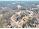 Expansive aerial view of the neighborhood with many homes surrounded by lush greenery at 8870 Dornoch Cir, Winston, GA 30187