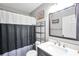 Bathroom with white vanity, sink, and gray shower curtain at 8870 Dornoch Cir, Winston, GA 30187