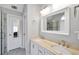 Bright bathroom featuring a double sink vanity, a walk-in shower and a framed mirror at 8870 Dornoch Cir, Winston, GA 30187