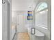 Bright bathroom featuring a standalone tub and a glass shower with a tiled surround at 8870 Dornoch Cir, Winston, GA 30187