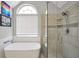 Bright bathroom featuring a standalone tub and a glass shower with a tiled surround at 8870 Dornoch Cir, Winston, GA 30187