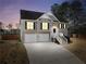 Two-story home with attached garage, well-lit with many windows, set against a night sky at 8870 Dornoch Cir, Winston, GA 30187