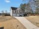 Charming two-story home with a well-manicured lawn and a two-car garage on a sunny day at 8870 Dornoch Cir, Winston, GA 30187