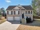 Inviting two-story home with two-car garage and well-maintained front yard at 8870 Dornoch Cir, Winston, GA 30187
