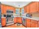 Bright eat-in kitchen with wood cabinets and stainless steel appliances at 8870 Dornoch Cir, Winston, GA 30187
