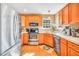 Bright eat-in kitchen with wood cabinets, stainless steel appliances, and hardwood flooring at 8870 Dornoch Cir, Winston, GA 30187