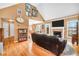 Spacious living room featuring hardwood floors and fireplace, flowing to a kitchen dining area at 8870 Dornoch Cir, Winston, GA 30187