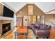 Inviting living room boasts a brick fireplace and a vaulted ceiling for a spacious feel at 8870 Dornoch Cir, Winston, GA 30187
