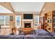 Bright living room features a brick fireplace, hardwood floors, and an abundance of natural light at 8870 Dornoch Cir, Winston, GA 30187