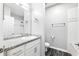 Bathroom with white cabinets, granite counters, and a shower and tub combination at 1250 Parkwood Circle Se # 1110, Atlanta, GA 30339