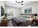 Well-lit bedroom showcasing a comfortable bed, stylish decor, and a large window with a view at 1250 Parkwood Circle Se # 1110, Atlanta, GA 30339