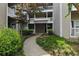 Apartment building exterior surrounded by lush greenery and a charming walkway at 1250 Parkwood Circle Se # 1110, Atlanta, GA 30339