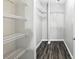 Walk-in closet with wire shelving and dark wood-look floors at 1250 Parkwood Circle Se # 1110, Atlanta, GA 30339